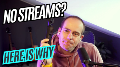 Frenck in a hoodie at his desk, earbuds in, holding a small camera; podcast mic in frame. On-screen text reads: NO STREAMS? HERE IS WHY.